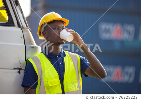 African American businessman drinking coffee, black man have coffee break at worksite outdoors container background 76225222