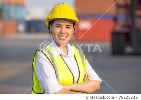 Portrait of logistic engineer worker woman foreman in hardhat and safety at containers cargo 76225239