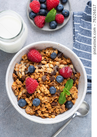 Homemade granola in bowl with berries Homemade granola in bowl with berries 76226817