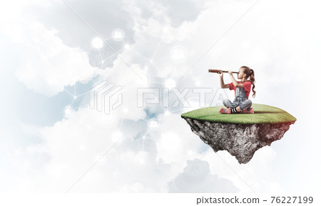 Concept of careless happy childhood with girl looking in spyglas 76227199