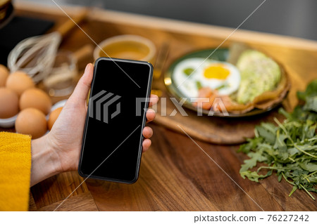 Smart phone with empty screen to copy paste breakfast recipe 76227242