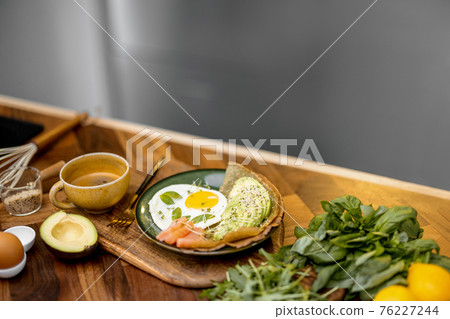 Eggs with fish and avocado for breakfast Eggs with fish and avocado for breakfast 76227244