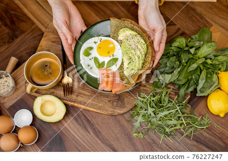 Eggs with fish and avocado for breakfast Eggs with fish and avocado for breakfast 76227247