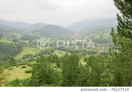 Misty hollow between the mountains. Summer morning. Landscape. Misty hollow between the mountains. Summer morning. Landscape. 76227529
