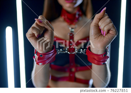 Female stripper in red leather handcuffs Female stripper in red leather handcuffs 76227851