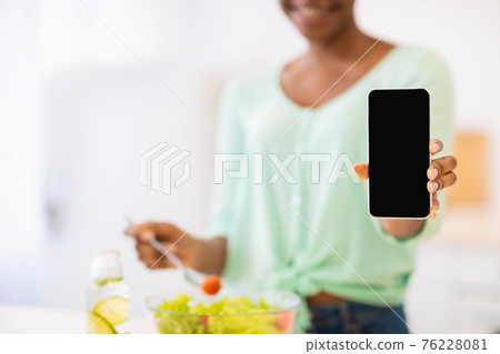 Unrecognizable African Female Showing Phone Screen Cooking In Kitchen, Cropped 76228081