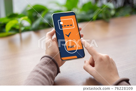 Unrecognizable woman paying for goods and services, using mobile app 76228109