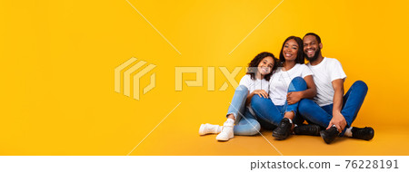 African American man, woman and girl sitting on floor 76228191