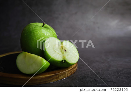 green apple on the black background green apple on the black background 76228193