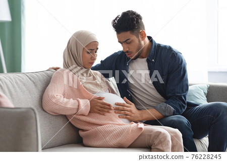 Painful Baby Movements. Pregnant Muslim Lady Suffering Abdominal Ache At Home Painful Baby Movements. Pregnant Muslim Lady Suffering Abdominal Ache At Home 76228245