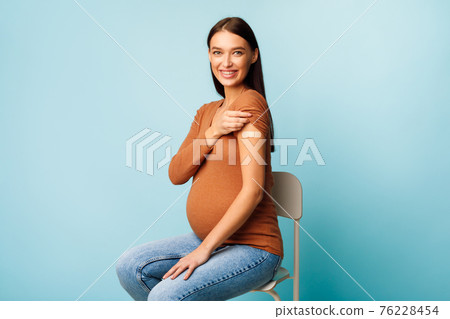 Pregnant Woman Vaccinated Against Covid-19 Showing Arm With Bandage, Studio 76228454