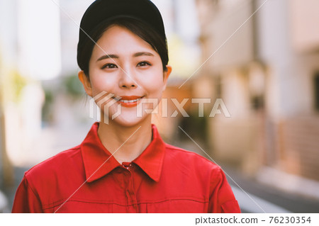 Young woman in red jumpsuit 76230354