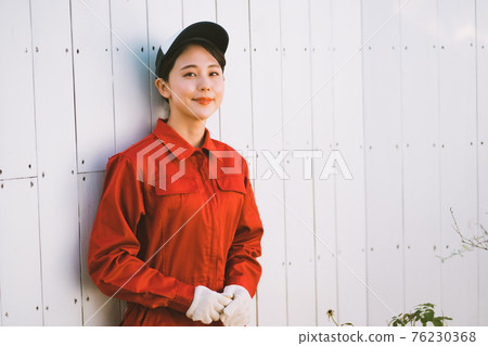Young woman in red jumpsuit 76230368