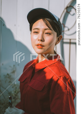 Young woman in red jumpsuit 76230374