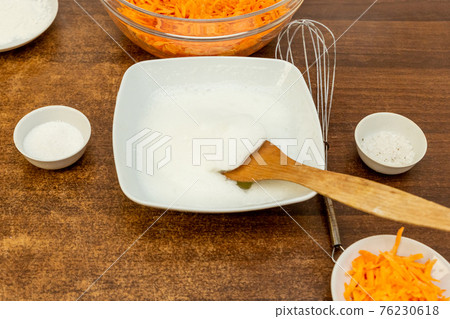 cooking delicious carrot muffin grated carrots, proteins, sugar and salt 76230618