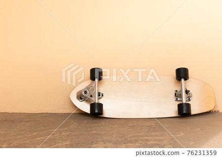 a surf skate or skateboard on dirty floor and concrete wall in. vintage tone. sport and recreation concept a surf skate or skateboard on dirty floor and concrete wall in. vintage tone. sport and recreation concept 76231359