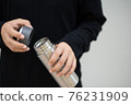 Female athlete opening the steel water bottle 76231909