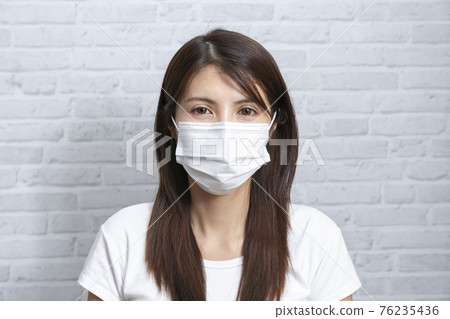 Asian young woman wear medical mask that protects against the spread of coronavirus or COVID-19 disease. Asian young woman wear medical mask that protects against the spread of coronavirus or COVID-19 disease. 76235436