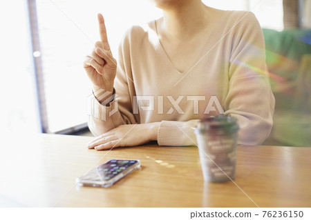 Woman operating a smartphone 76236150