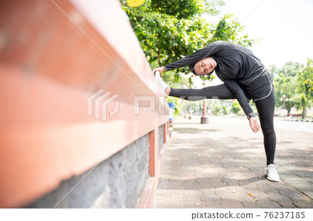 muslim asian woman strecth her leg during sport time outdoor muslim asian woman strecth her leg during sport time outdoor 76237185