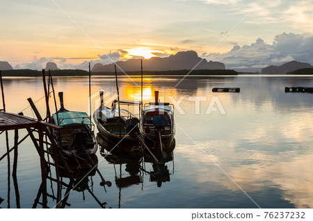 Ban Sam Chong Tai and colorful sunrises that emerges behind the giant limestone mountains. Ban Sam Chong Tai and colorful sunrises that emerges behind the giant limestone mountains. 76237232