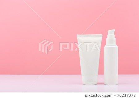 Two white cosmetic tubes on white table against pink background with copy space.Face cream, lotion or balm concept Two white cosmetic tubes on white table against pink background with copy space.Face cream, lotion or balm concept 76237378