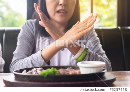 Hands woman refusing food in restaurant,No meal,Diet food concept 76237558