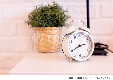 Modern alarm clock white color at the bedroom in the morning 76237559