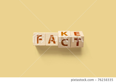 Fact or Fake concept. Wooden cube shape flip change the word. April fools day Fact or Fake concept. Wooden cube shape flip change the word. April fools day 76238335