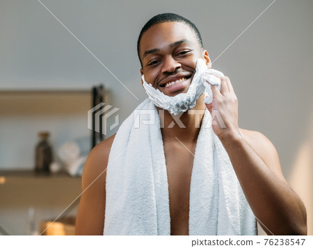 male facial care african man applying shaving foam male facial care african man applying shaving foam 76238547