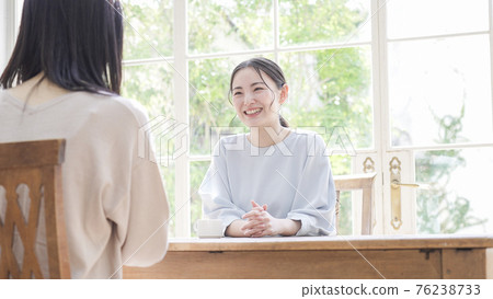 Mother and daughter talking with a smile Mother and daughter talking with a smile 76238733