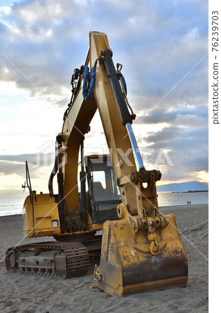 Power shovel working on the sandy beach of the coast Power shovel working on the sandy beach of the coast 76239703