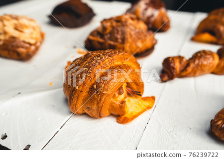 Freshly baked traditional bread on wooden table Freshly baked traditional bread on wooden table 76239722