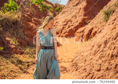 Woman tourist in red canyon, resumption of tourism concept Woman tourist in red canyon, resumption of tourism concept 76240400