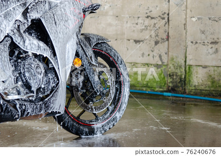 Clean up the motorcycle wash at the car wash shop Clean up the motorcycle wash at the car wash shop 76240676