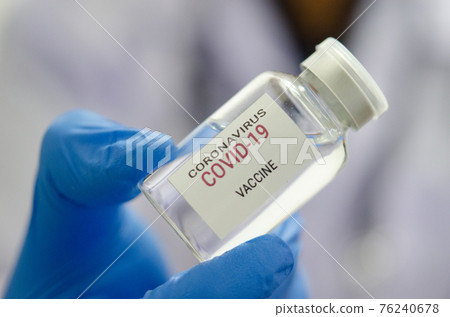 Doctor or laborant holding COVID-19 vaccine tube Or coronavirus vaccine Doctor or laborant holding COVID-19 vaccine tube Or coronavirus vaccine 76240678