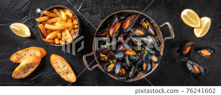 Mussels panorama with lemon, fries, and toasted bread Mussels panorama with lemon, fries, and toasted bread 76241602