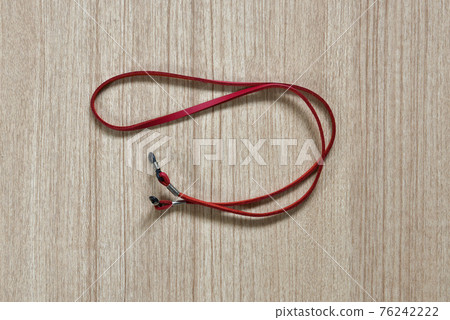 leather red eyeglasses strap on a wooden background leather red eyeglasses strap on a wooden background 76242222