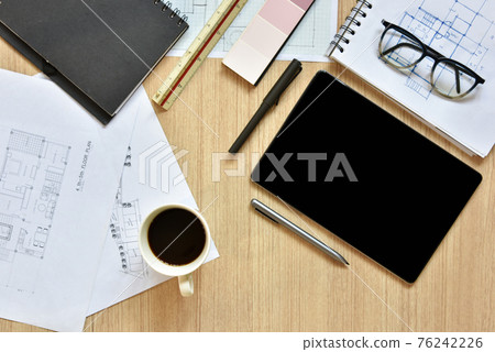 a top view of architect working desk with equipments for drawings pens sketched idea on wood table, the concept of modern technology for architectural working with tablet a top view of architect working desk with equipments for drawings pens sketched idea on wood table, the concept of modern technology for architectural working with tablet 76242226