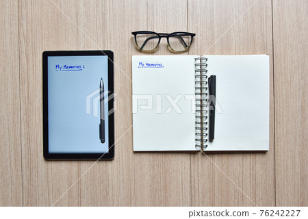 a tablet and notebook with pens and eyeglasses on wood table,old and new style of technology to note and take a memo for note or lists concept a tablet and notebook with pens and eyeglasses on wood table,old and new style of technology to note and take a memo for note or lists concept 76242227