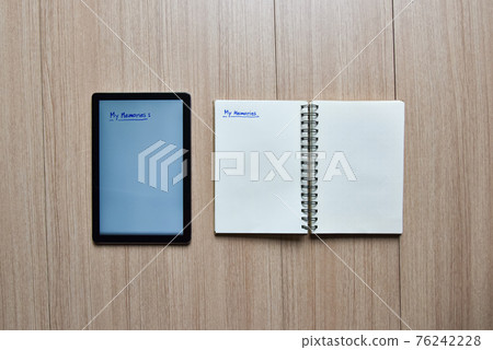 a tablet and notebook on wood table,old and new style of technology to note and take a memo for note or lists concept a tablet and notebook on wood table,old and new style of technology to note and take a memo for note or lists concept 76242228