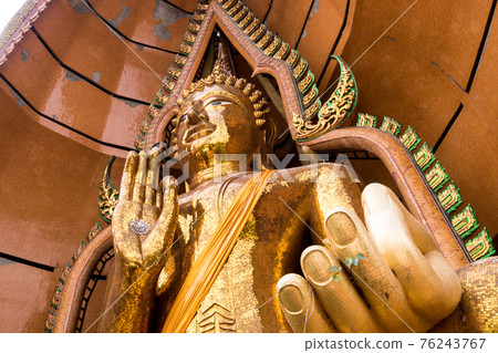 Silver chrysanthemum symbol and gold leaf In the palm of the Buddha statue Silver chrysanthemum symbol and gold leaf In the palm of the Buddha statue 76243767
