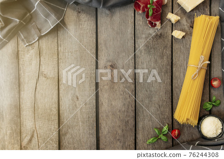 Italian cuisine concept. Parmesan Cheese chunks, pasta, ham, tomatos, basil Italian cuisine concept. Parmesan Cheese chunks, pasta, ham, tomatos, basil 76244308