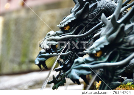 Water coming out of the dragon's mouth Water coming out of the dragon's mouth 76244704