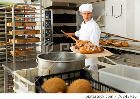 Usual work of baker in bakery 76245416