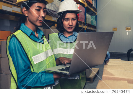 Female warehouse worker working at the storehouse 76245474