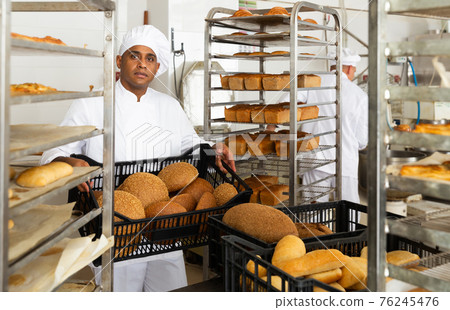 Male baker with box of bread at bakery 76245476