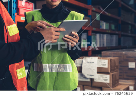 Female warehouse worker working at the storehouse Female warehouse worker working at the storehouse 76245639