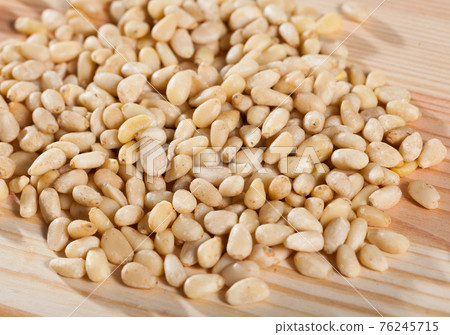 Photo of mix raw pine nut on the wooden desk Photo of mix raw pine nut on the wooden desk 76245715