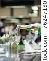 Pouring champagne into a glass 76247180